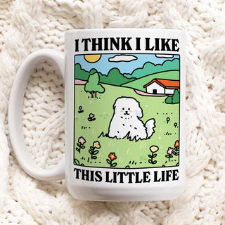 White mug with a cartoon design of a dog in a field and text on a white background