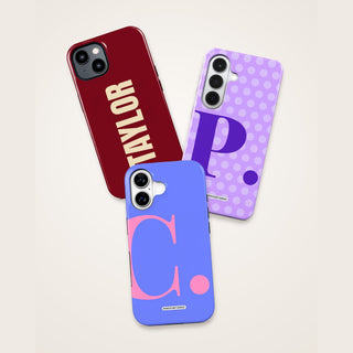 Three personalised phone cases with a bold name and initials